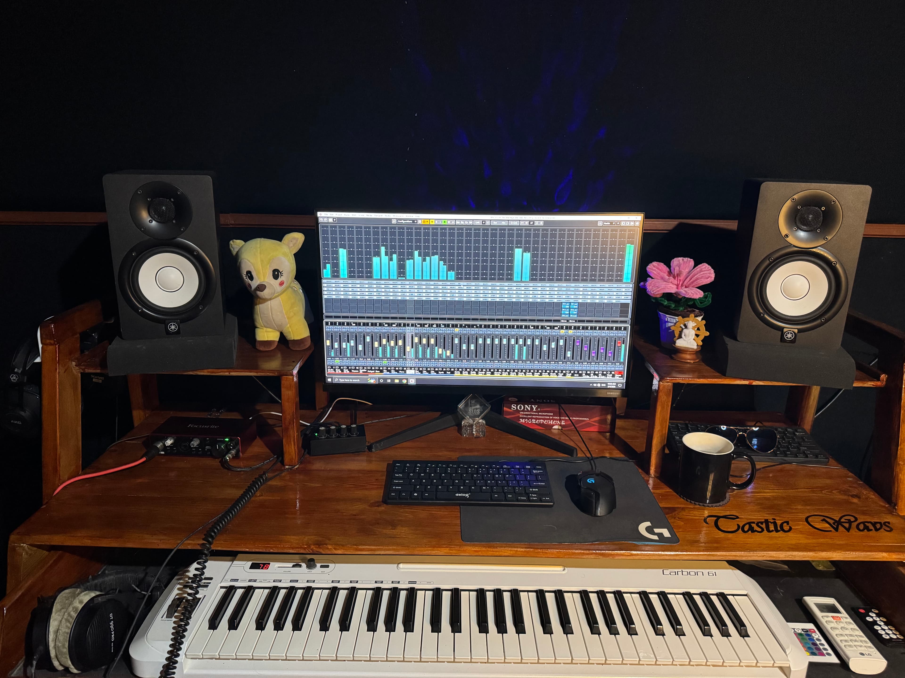 Centered view of the studio monitor speakers, display, desk controls, and keyboard at Tastic Wavs.